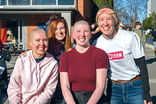 Christina Shepherd (Old Collegian 2017) and Alexandra Shepherd (St Andrew's College student) after shaving their heads to fundraise, with past staff member and mother Maxine Shepherd, and a Canteen staff member.