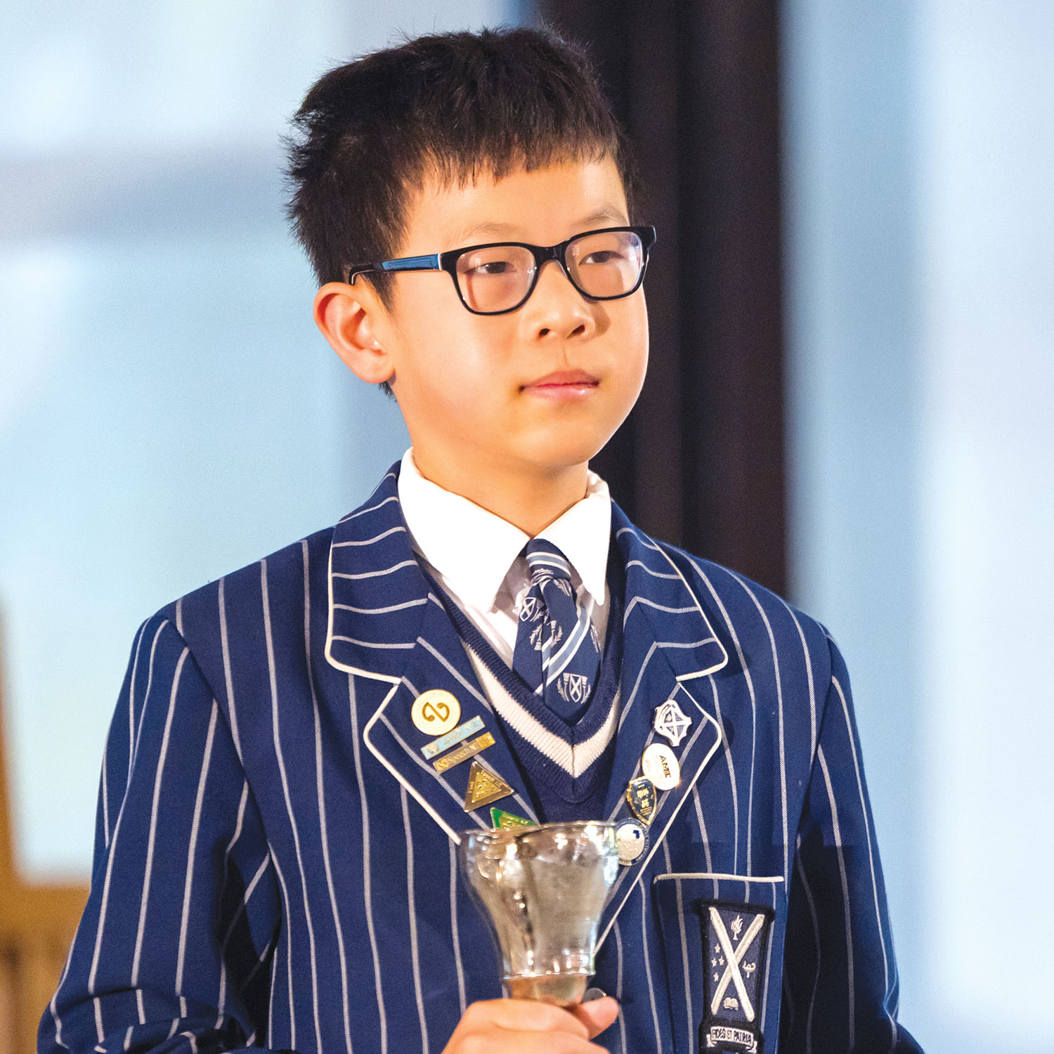 St Andrew's College student Cong (Zilong) Chen with award at Preparatory School Assembly.