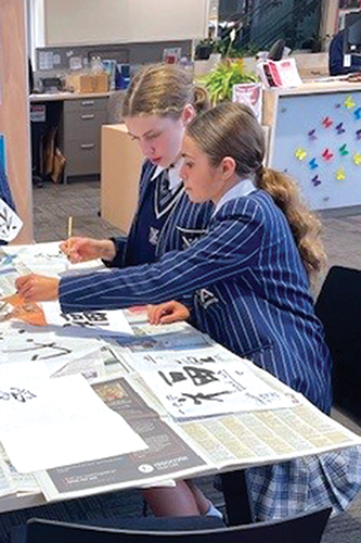 St Andrew's College students taking part in a Chinese calligraphy session.