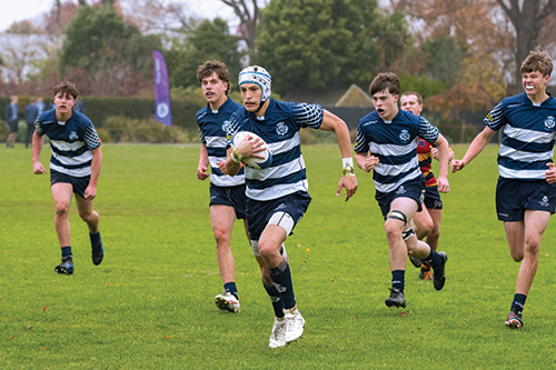 St Andrew's College students playing rugby.