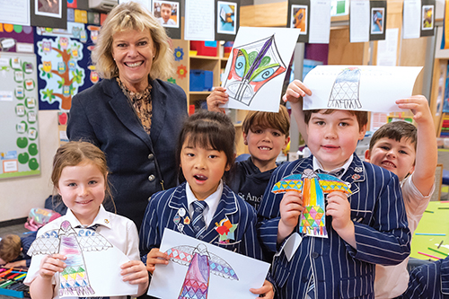 St Andrew's College Rector Christine Leighton and Junior students with their Matariki artwork.