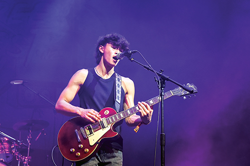 St Andrew's College student Ethan Lam playing the electric guitar and singing.