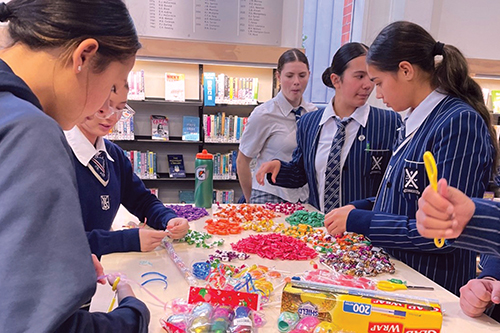 St Andrew's College students participating in ula lole (lolly necklace) making during Samoan Language Week.