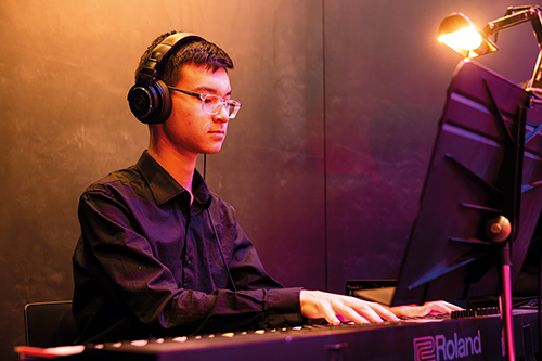 St Andrew's College student Sea-am Thompson playing the keyboard.