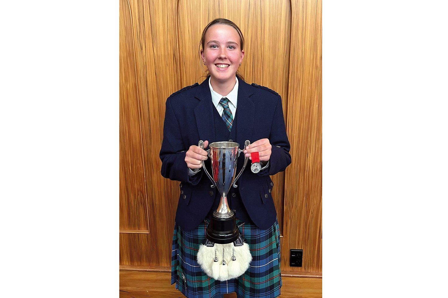 St Andrew's College piper Maggie McConnochie won a silver medal and a trophy at the Easter Hawkes Bay Highland Games competition.