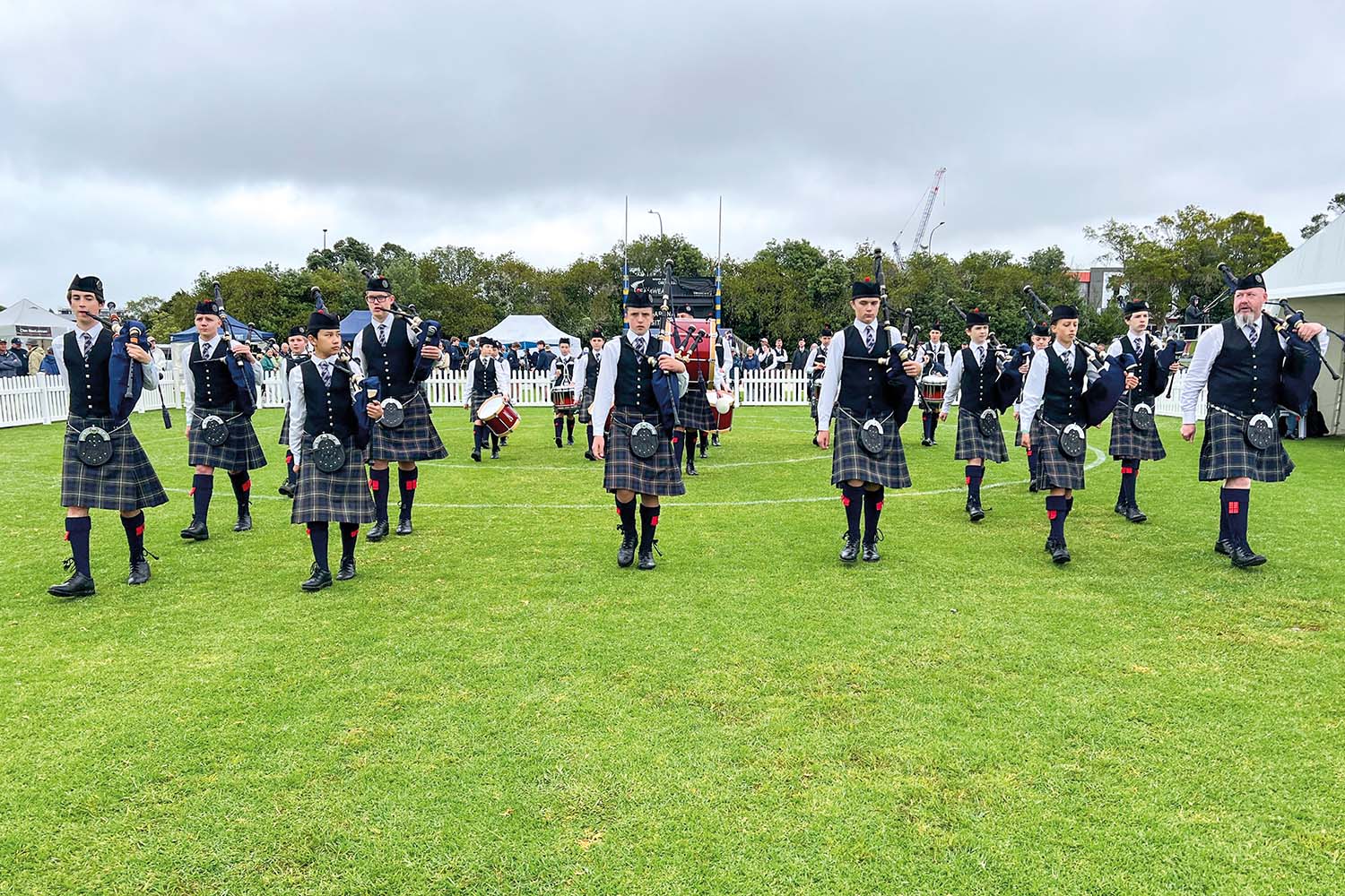 St Andrew's College Pipe Band members and staff at the 2024 New Zealand Pipe Band Championships.
