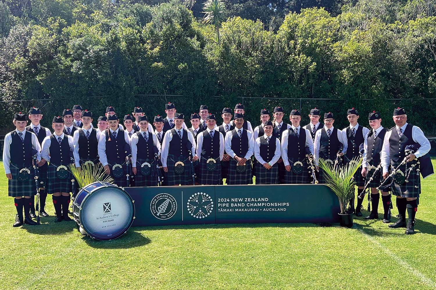 St Andrew's College Pipe Band members and staff at the 2024 New Zealand Pipe Band Championships.