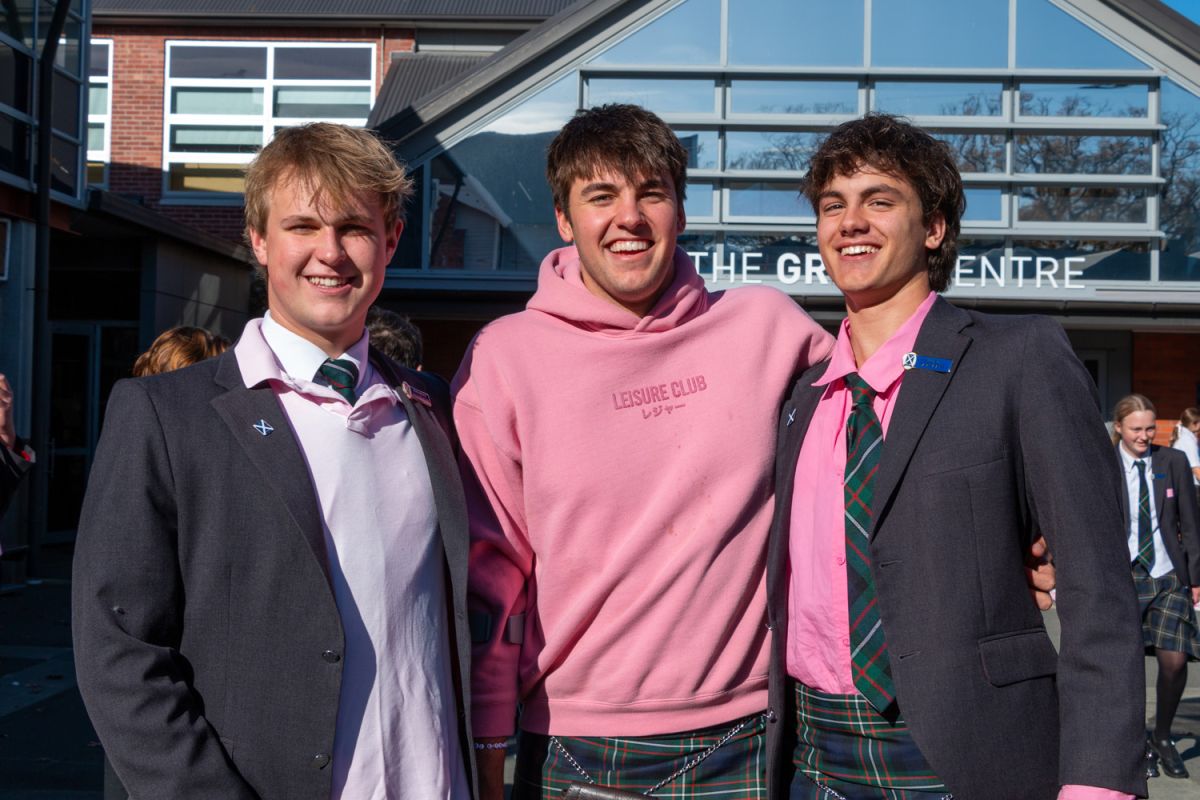 Three St Andrew's College Senior College students during Pink Shirt Day against bullying.