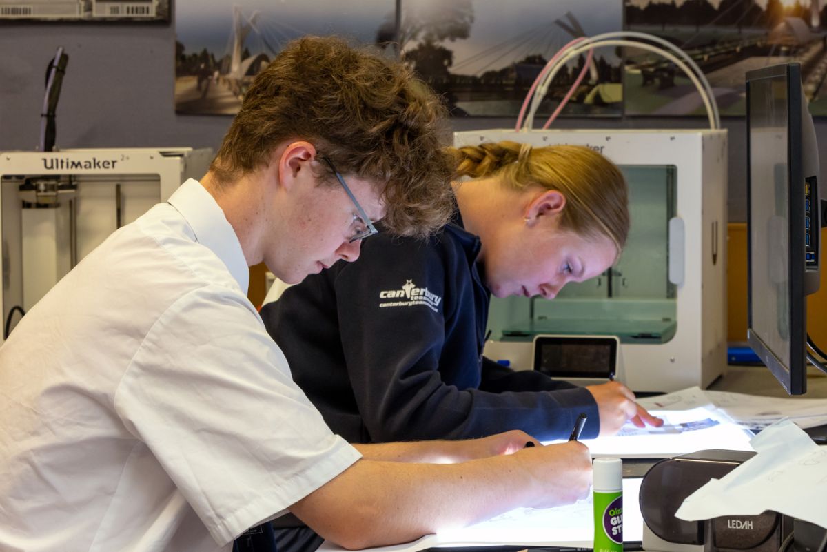 Two St Andrew's College students studying.