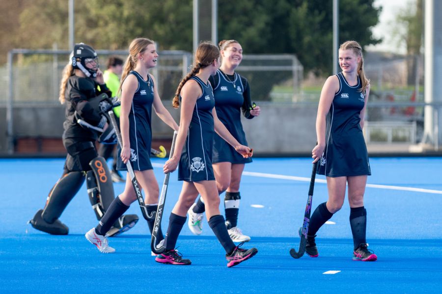 St Andrew's College female hockey players on hockey pitch