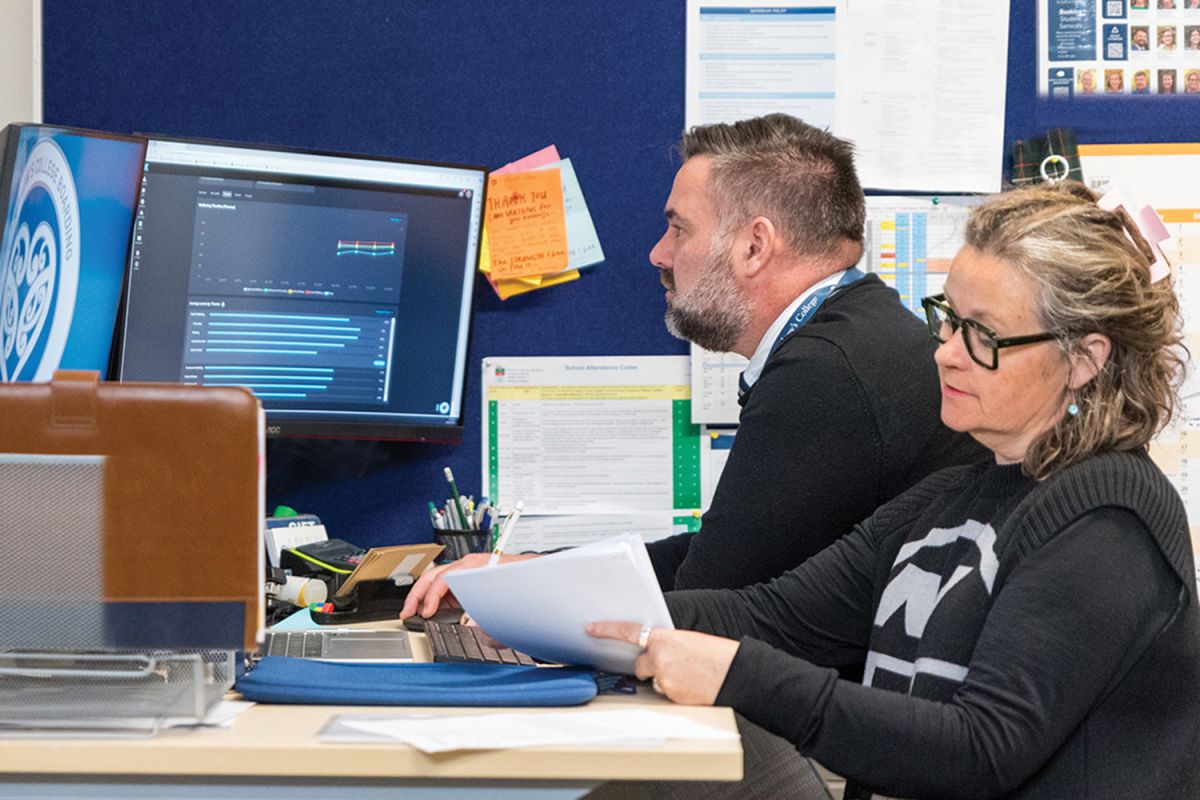 St Andrew's College Head of Middle School and Director of Boarding, Matt Parr and Assistant Head of Middle School and Year 10 Dean, Liz Gormack checking data on the Komodo student well-being programme.