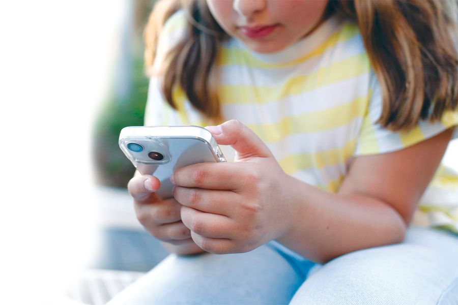 A girl using a mobile phone.