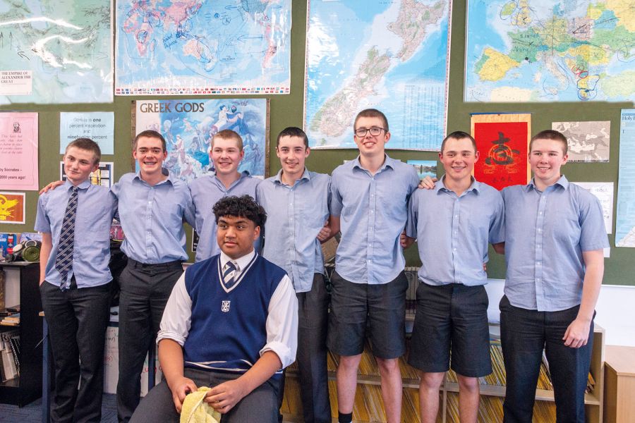 St Andrew's College male students posing together after getting a haircut to raise money for charity.