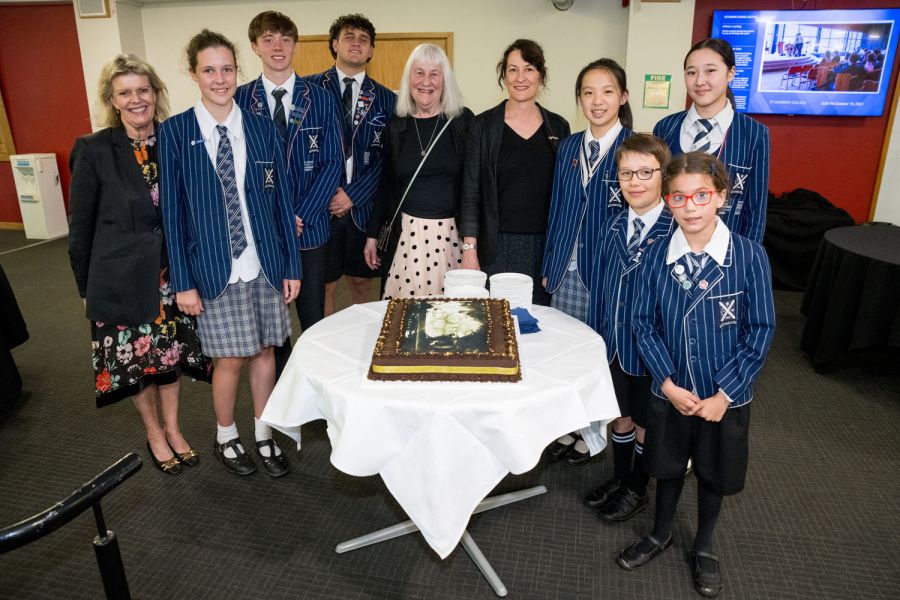 Kerrin at her book launch with Rector, Assistant Head of Secondary School, seven St Andrew's College students and a celebratory cake.