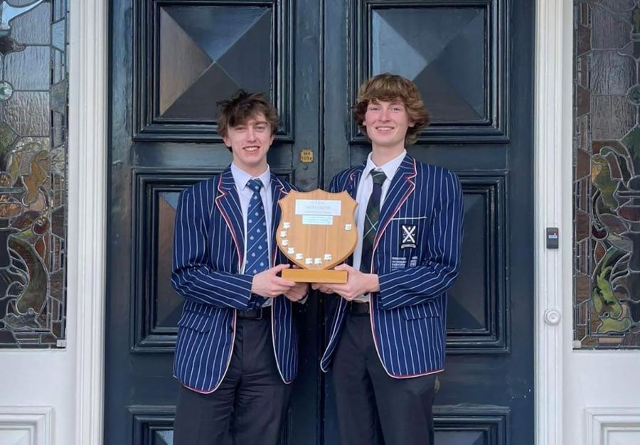 Two St Andrew's College students, James Hart and Luke Wylie, holding the Canterbury Impromptu Debating Cup.