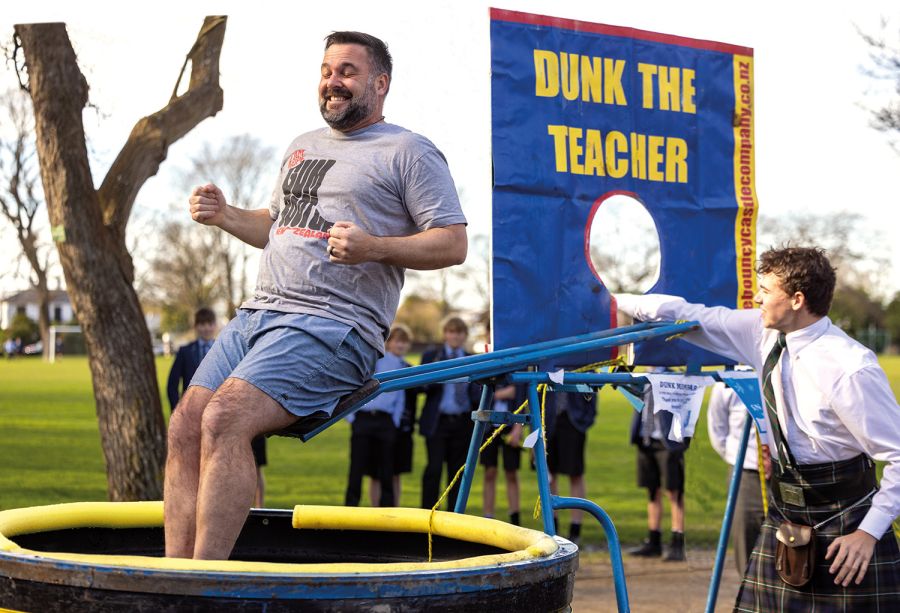 St Andrew's College student dunking Head of Middle School in water as part of a fundraiser for local charity.