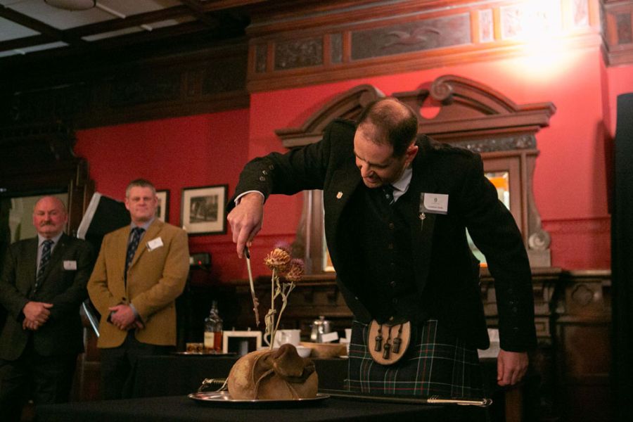 OCA President, Jonathan Wells (1987) performing the Blessing of the Haggis at the Annual Dinner