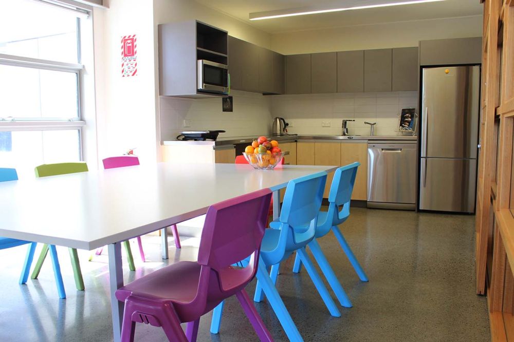 Boarding house kitchen area with table and chairs