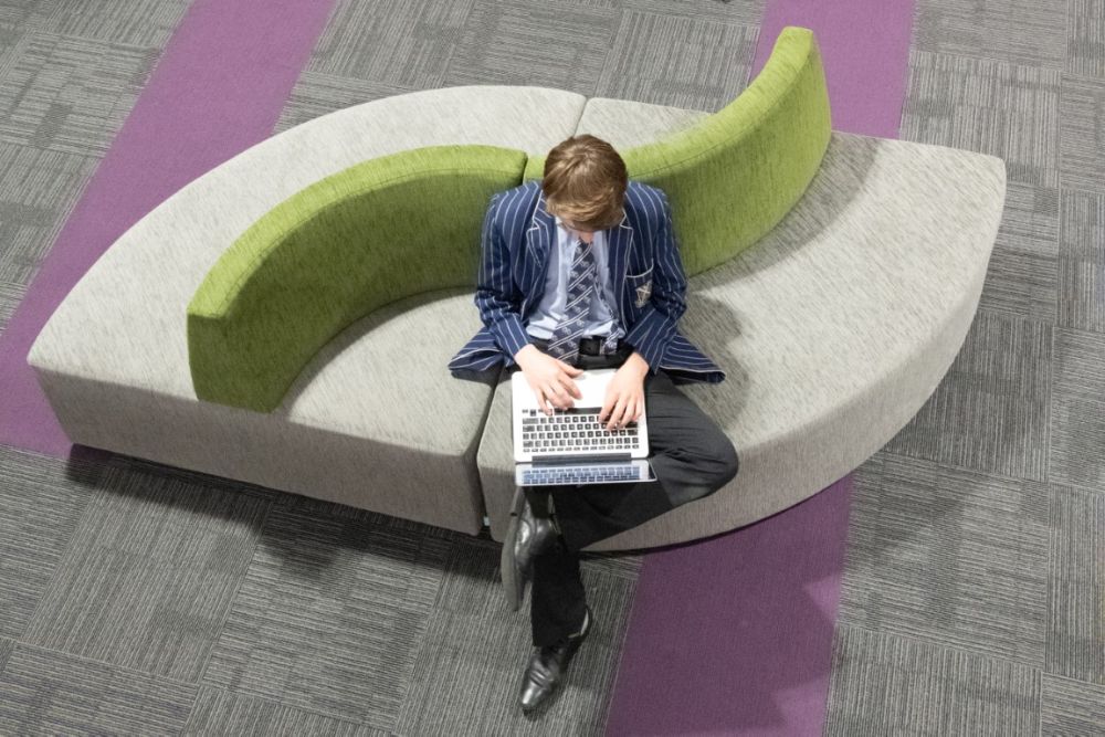 Student sat in Green Library and Innovation Centre on laptop