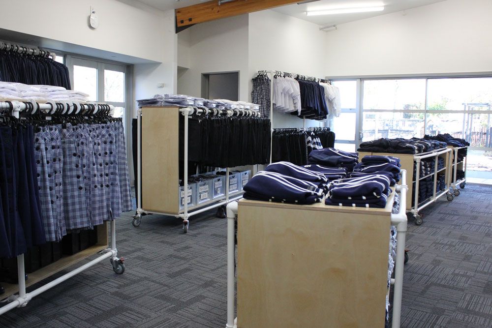 St Andrew's College shop Thistles interior with clothes on racks