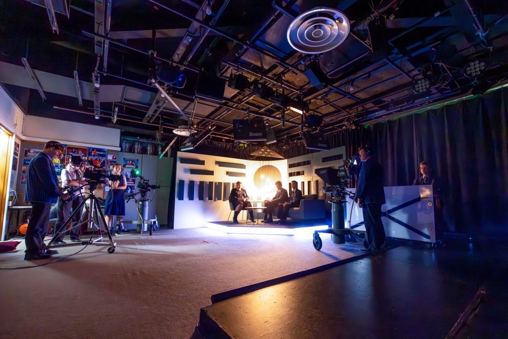 TV studio room with cameras and students