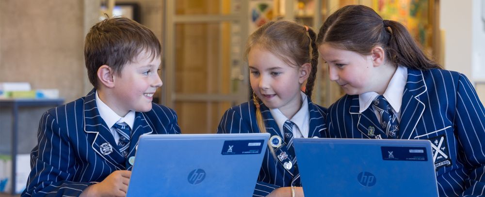 Preparatory students on laptops in the classroom.