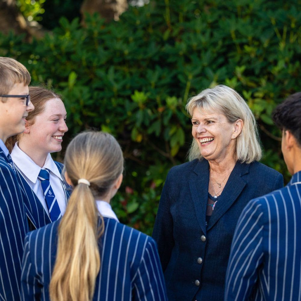Christine Leighton with students outside chatting