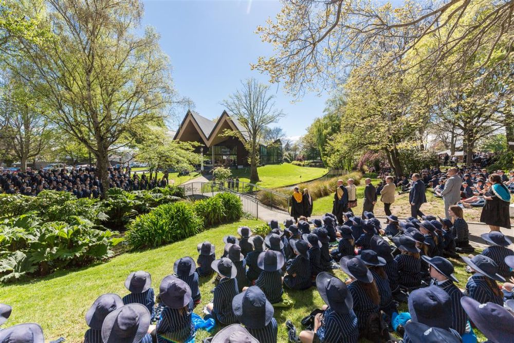 Students and guests gathered on the riverbank during the Centennial Chapel Dedication event