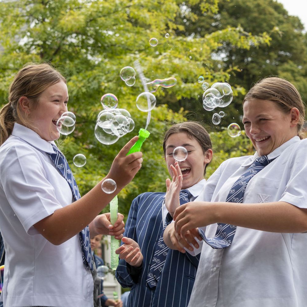 Students playing with bubbles in the quad.