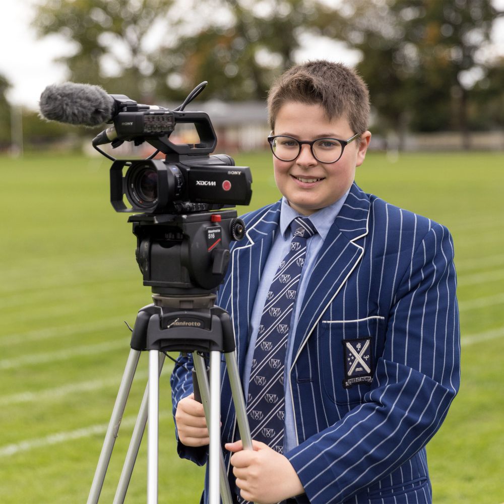 Student filming at Athletics Day.
