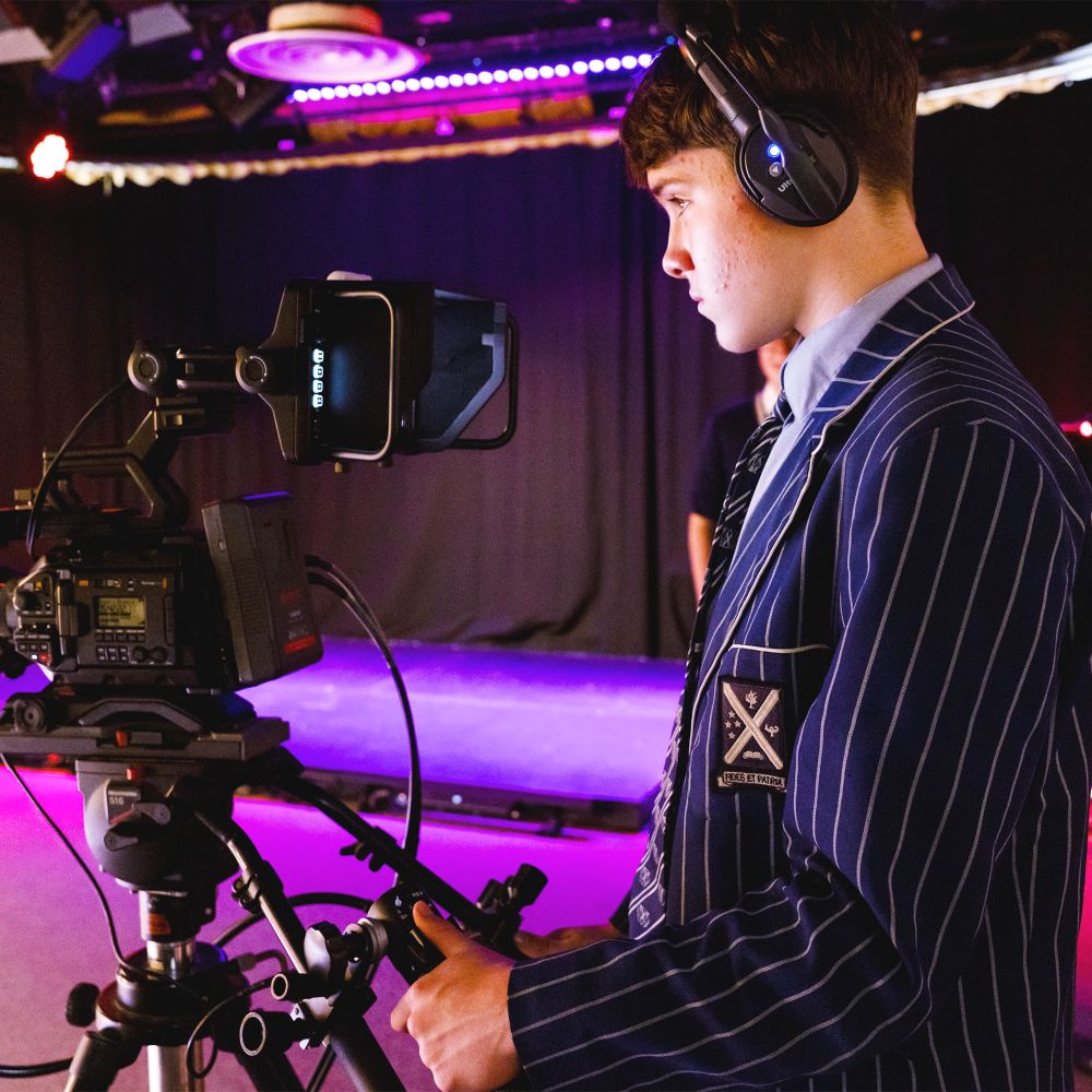 Student filming in the tv studio.