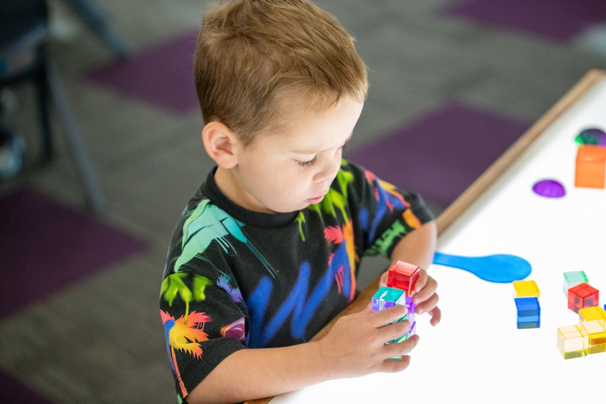 Child playing with coloured blocks at St Andrew's College Pre-school.