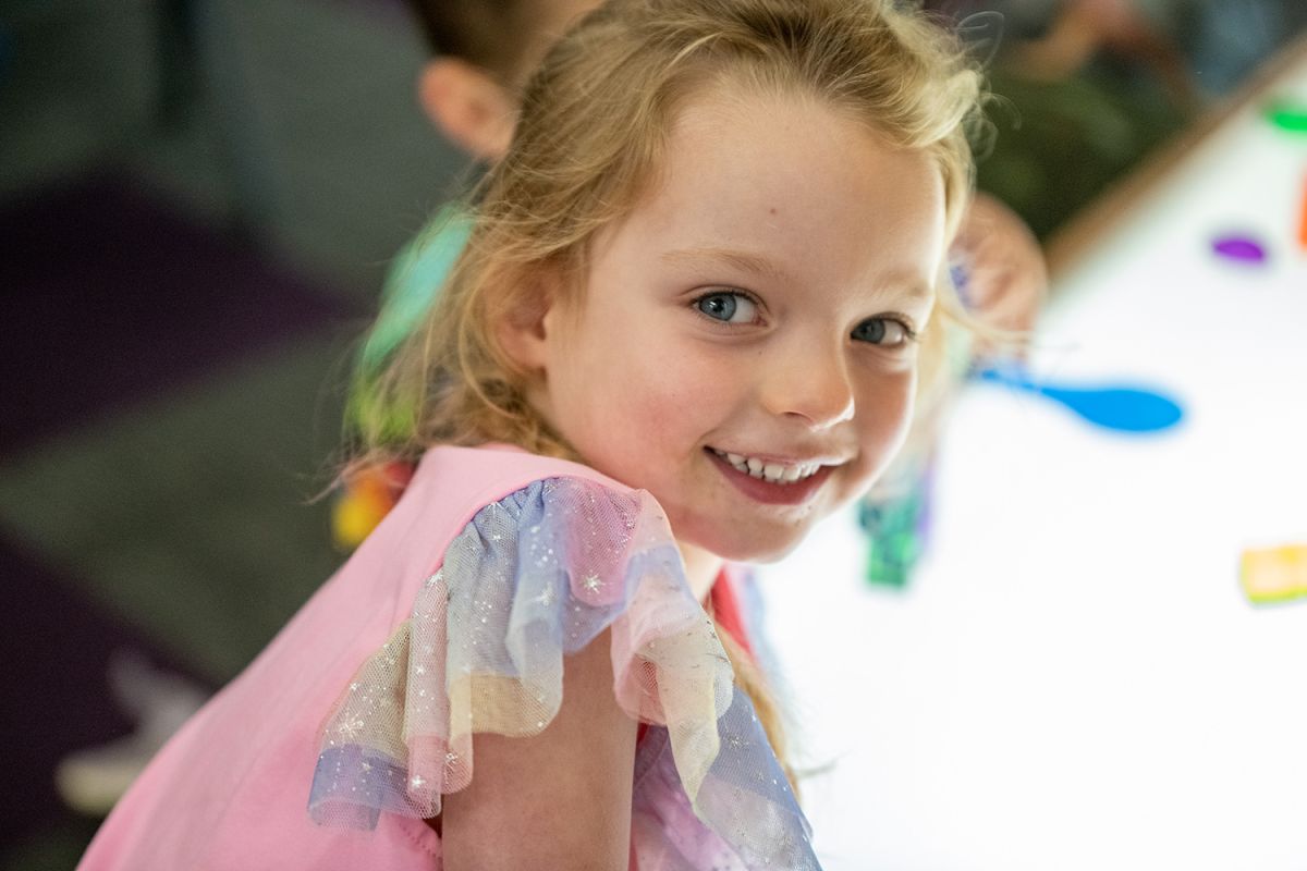 Child smiling at St Andrew's College Pre-school.