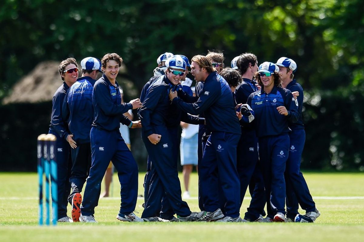 Cricket players celebrating after taking a wicket