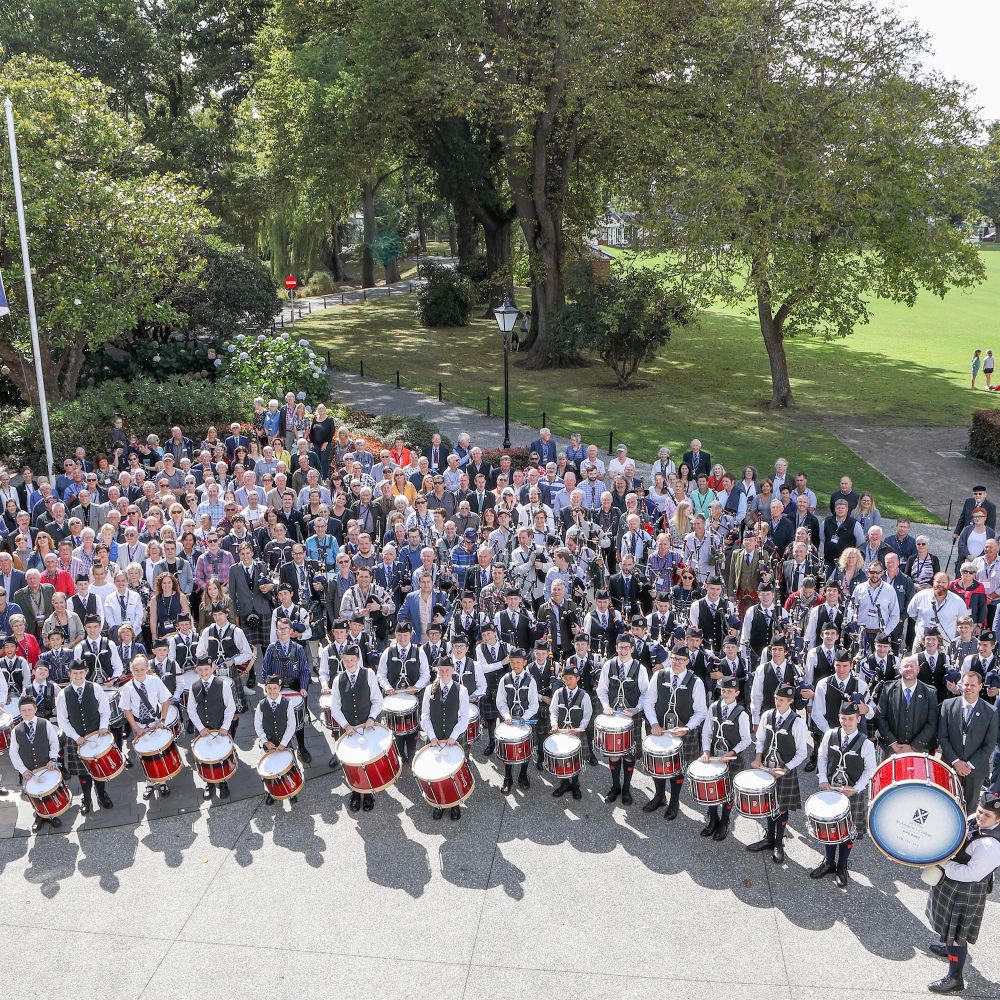 Overhead shot of attendees and the current Pipe Band at the Pipe Band centenary.