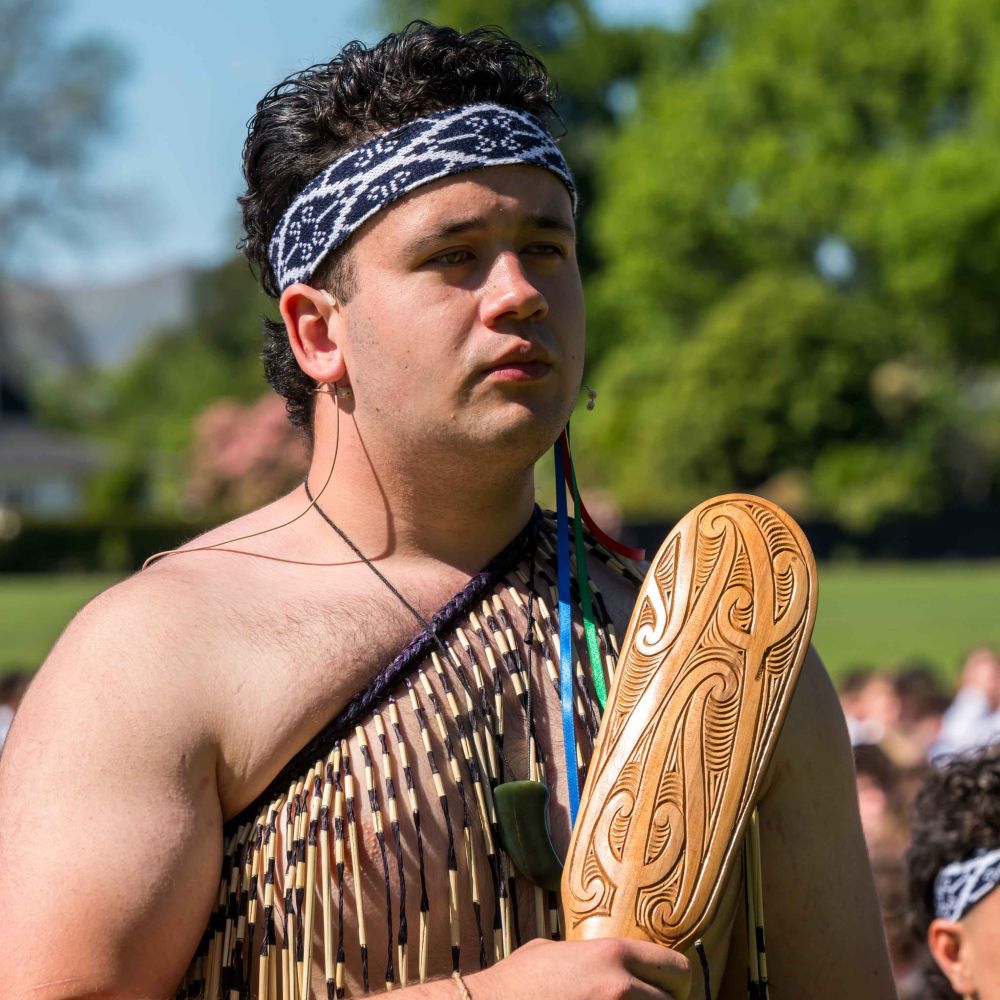 St Andrew's College student performing a haka in traditional dress