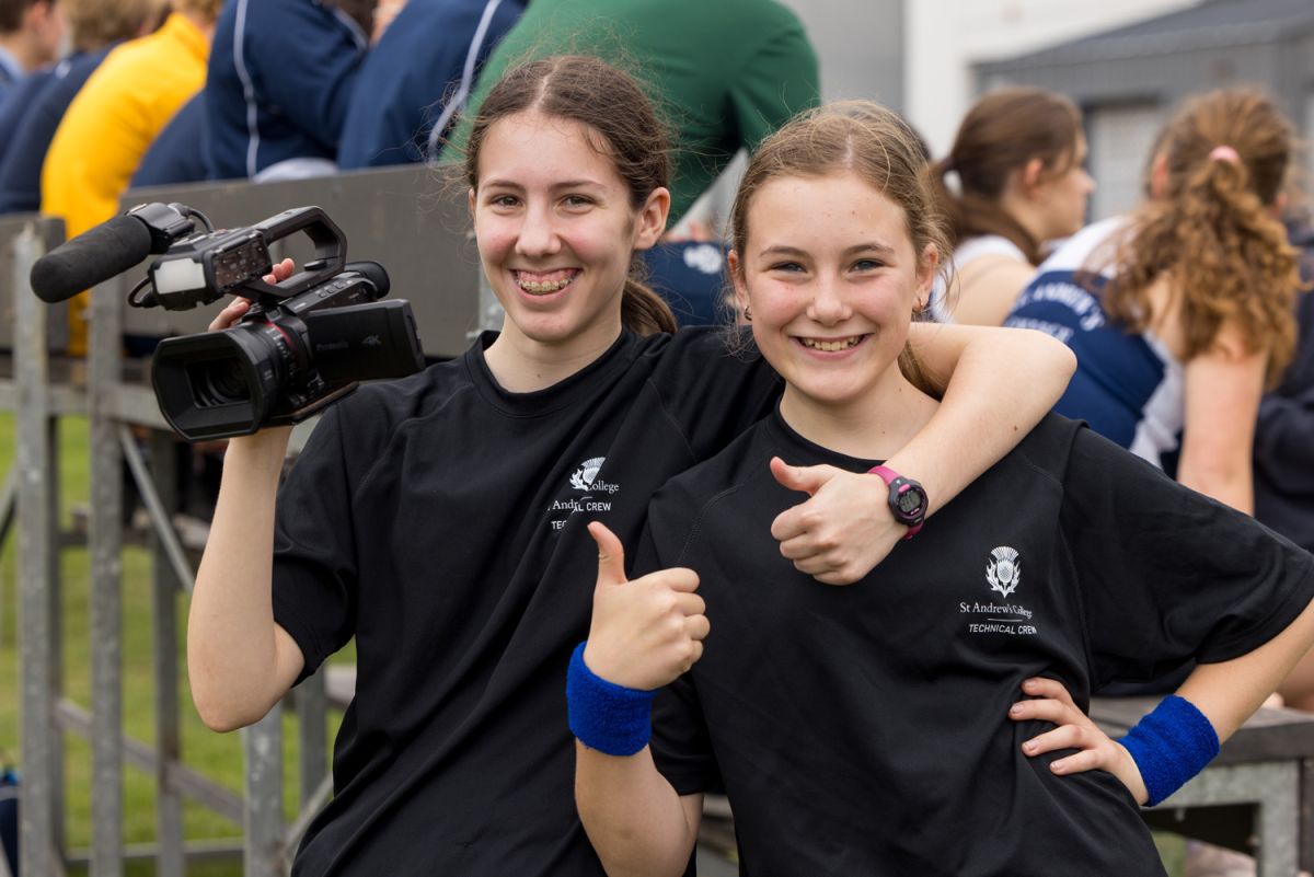 Two St Andrew's College students with a video camera.