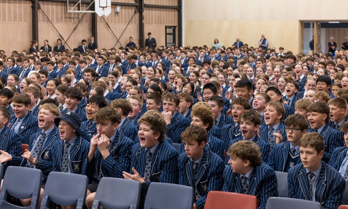 St Andrew's College Middle School students cheering on at an assembly.